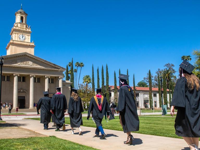 Students walking toward the Memorial Chapel during graduation.